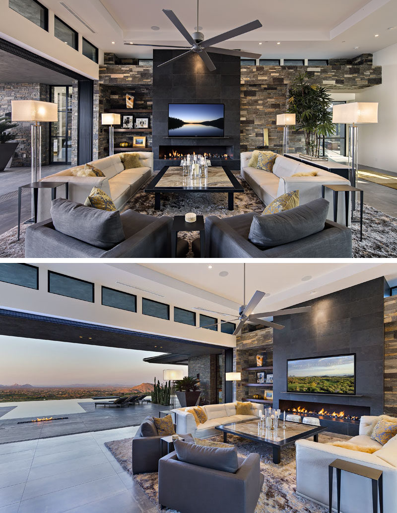 Living Room Ideas - In this modern living room, the seating is focused on the built-in fireplace that sits below the television, while walls of glass can be opened to connect to the outdoor spaces. #LivingRoom #Fireplace #ModernLivingRoom #LivingRoomIdeas