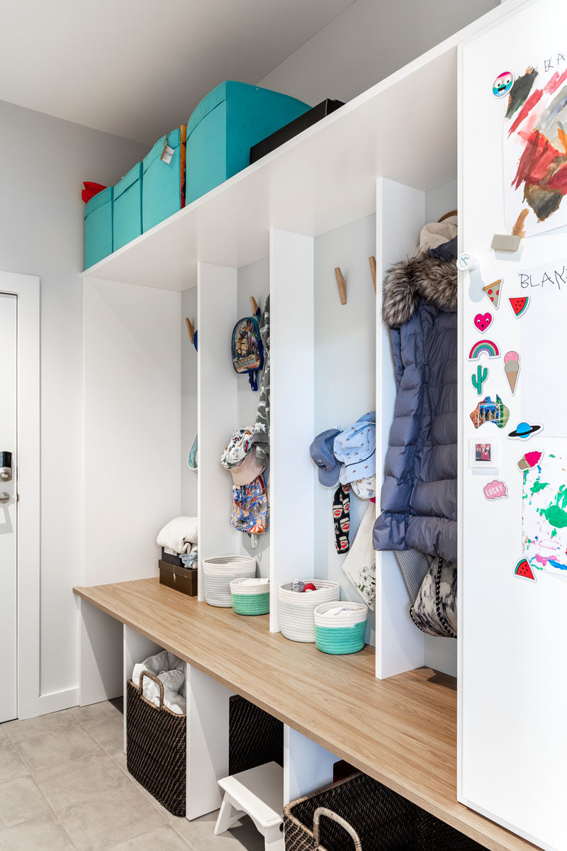 Mudroom Ideas - This mudroom has individual cubbies with hooks to give each child their own space to storage hats, jackets, and shoes. #MudroomIdeas #MudroomDesign