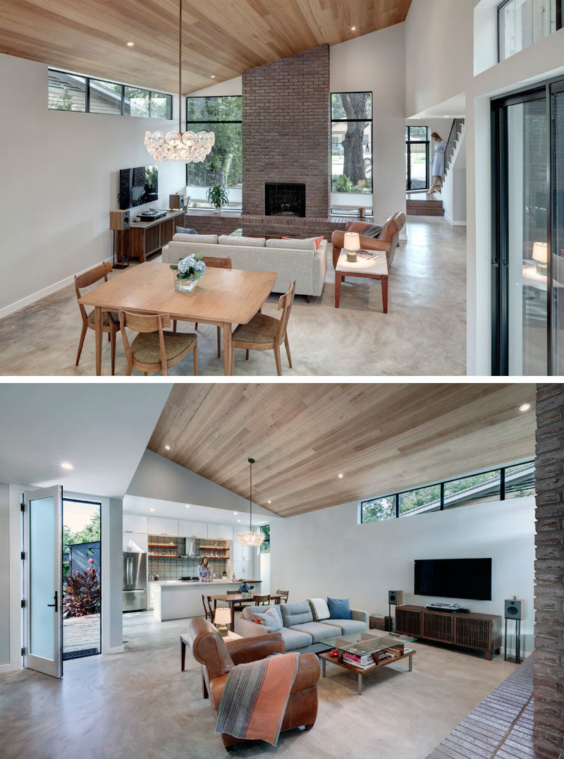 The open plan main floor of this modern house has the living room, dining room, and kitchen sharing the space. #ModernInterior #OpenPlanInterior #WoodCeiling