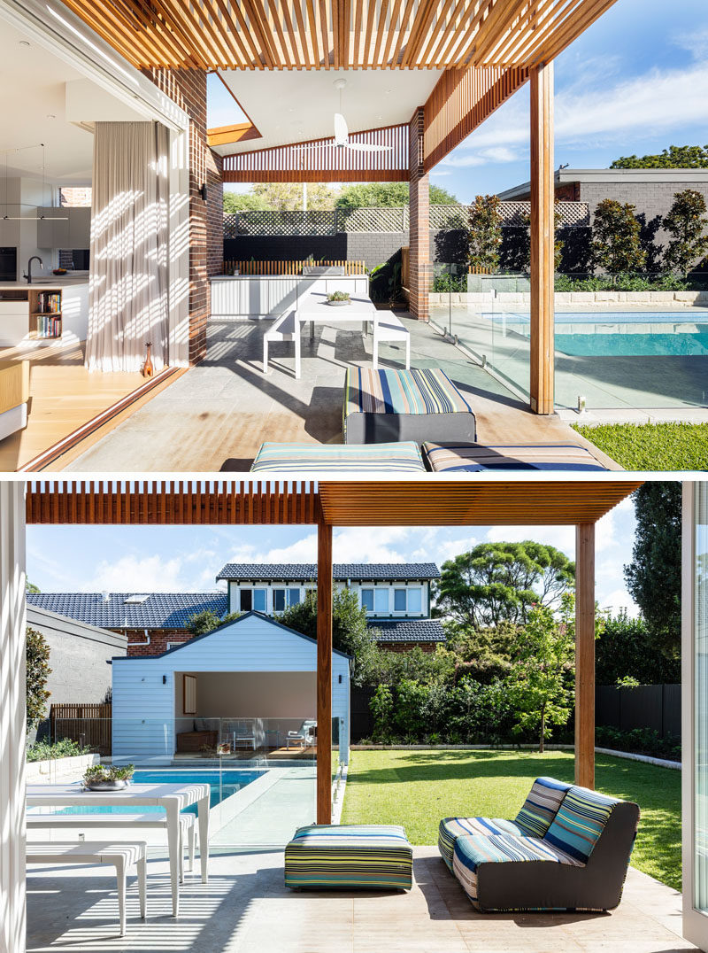 Outdoor Spaces - Both the kitchen and the living room of this renovated house open to the patio, that has an outdoor kitchen, a covered dining area, and space for a couple of comfy outdoor chairs. Timber slats help to provide privacy from the neighbors. #OutdoorSpace #Patio