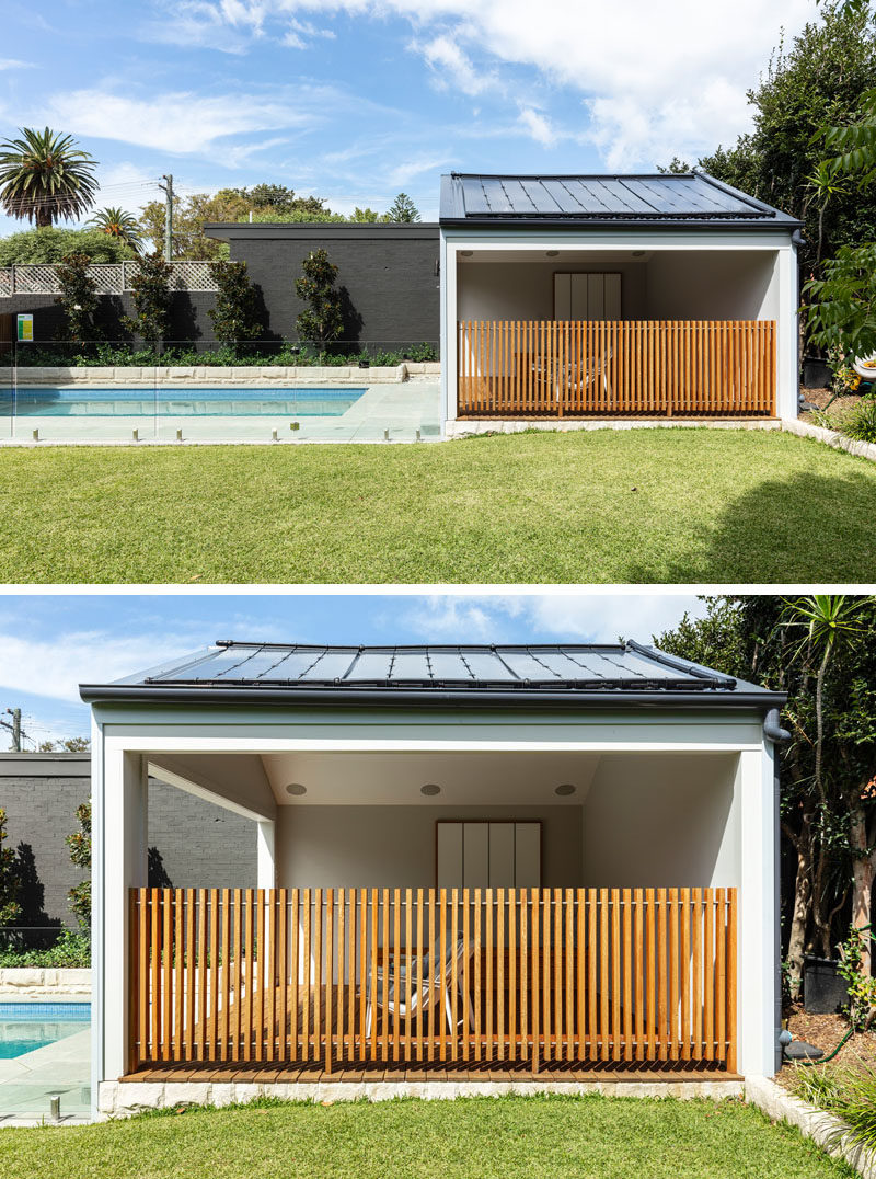 Swimming Pool Ideas - A swimming pool, surrounded by a glass safety fence sits next to a grassy lawn, while a cabana provides shade on a sunny day. #SwimmingPoolIdeas #SwimmingPool #Cabana