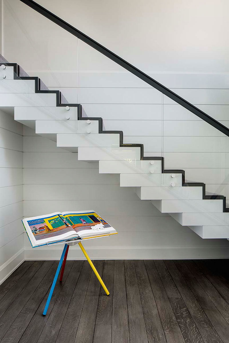 Stair Ideas - This contemporary house features a floating box staircase with a glass panel railing. #Stairs #StairIdeas #Staircase #GlassRailing #GlassHandrail