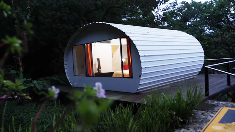 A curved metal tiny house