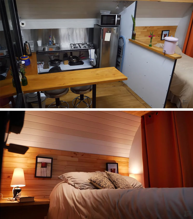 A tiny house with a small kitchen and open bedroom.