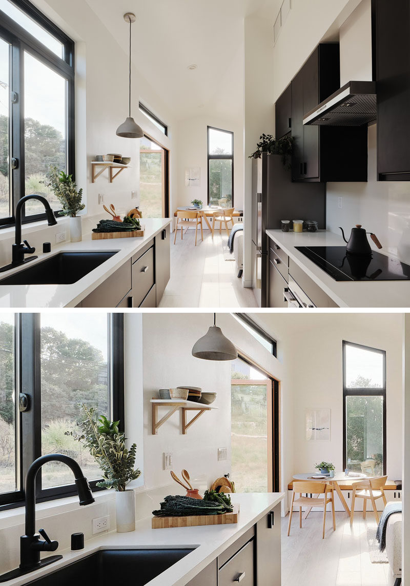 Tiny House Ideas - In this modern tiny house, the kitchen doubles as a hallway to the bedroom and bathroom, while the black cabinets contrast the light walls and white quartz countertops, and complement the black window frames. #TinyHouseKitchen #ModernKitchen #BlackKitchen #SmallKitchen