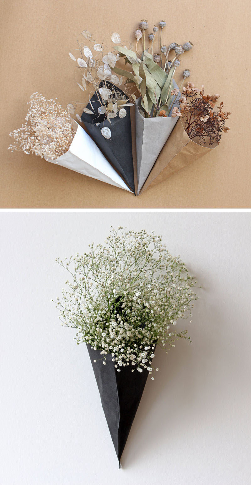 Wall Decor Idea - These modern cone-shaped wall planters and storage pieces are made from a material that looks like paper. #ModernDecor #WallDecorIdeas #ModernWallPlanters #StorageIdeas #WallStorage