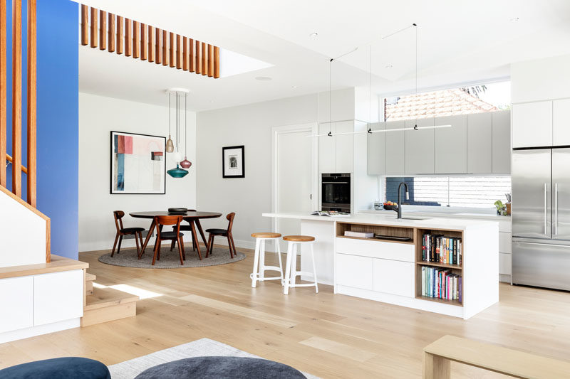 This renovated home opens up into a large dining, kitchen, and living room. #DiningRoom #ModernKitchen