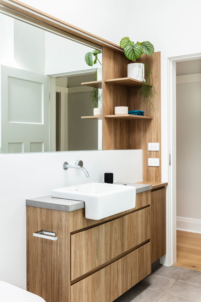 Bathroom Ideas - Open wood shelving provides additional storage and a natural element in this modern bathroom. #BathroomDesign #BathroomIdeas #ModernBathroom