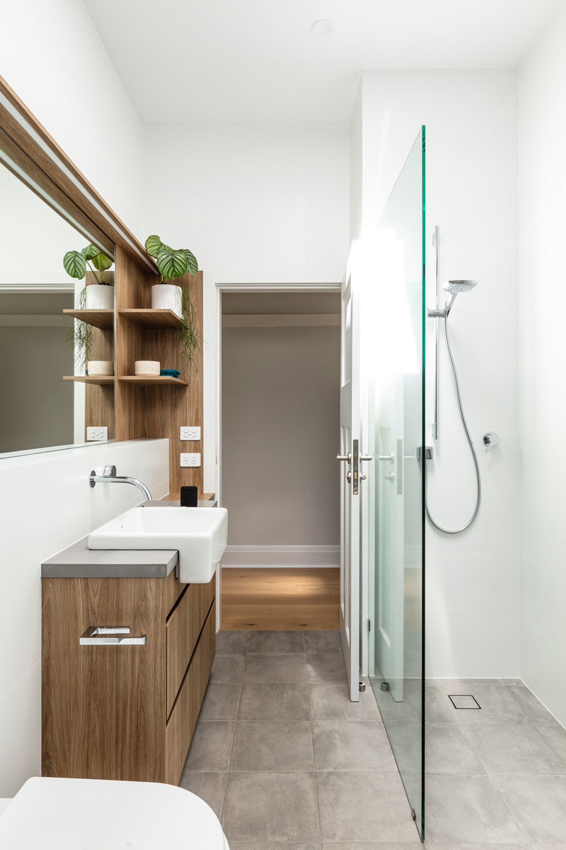 Bathroom Ideas - Open wood shelving provides additional storage and a natural element in this modern bathroom. #BathroomDesign #BathroomIdeas #ModernBathroom