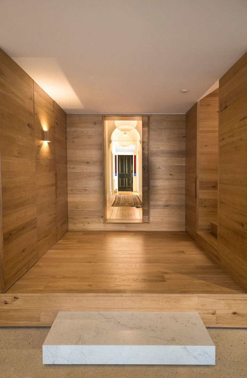 This wood lined foyer separates the old part of the house from the new modern addition. #Foyer #Stairs 