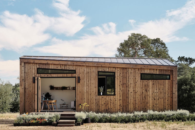 Drawing influence from the Californian coast, this modern tiny house showcases naturally-stained cedar siding and a standing-seam metal roof. #ModernTinyHouse #TinyHouseIdeas #TinyHouseArchitecture #TinyHouseDesign #TinyHouse
