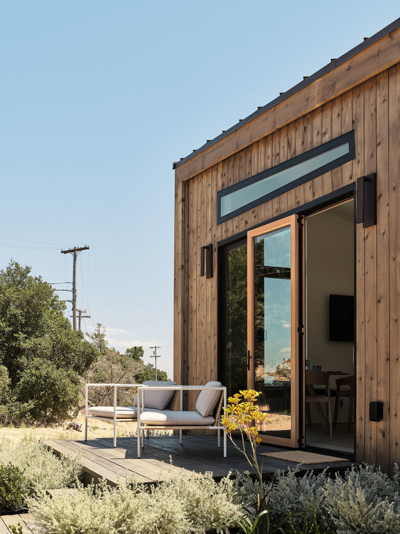 Tiny House Ideas - Drawing influence from the Californian coast, this modern tiny house showcases naturally-stained cedar siding and a standing-seam metal roof. #ModernTinyHouse #TinyHouseIdeas #TinyHouseArchitecture #TinyHouseDesign #TinyHouse