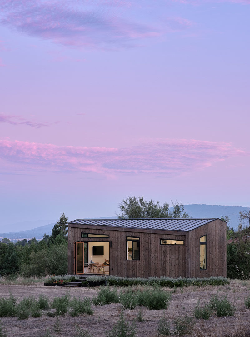 Tiny House Ideas - Drawing influence from the Californian coast, this modern tiny house showcases naturally-stained cedar siding and a standing-seam metal roof. #ModernTinyHouse #TinyHouseIdeas #TinyHouseArchitecture #TinyHouseDesign #TinyHouse