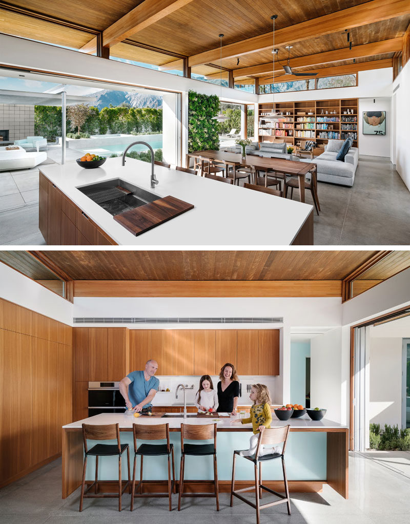 Kitchen Ideas - In this modern kitchen, minimalist wood cabinets have been made from reconstituted poplar, that's been dyed to resemble an engineered teak. These cabinets add warmth to the space, and contrast the white surfaces, backsplash, and storage accessories from Corian. #ModernKitchen #WoodKitchen #ModernKitchenDesign #KitchenIdeas