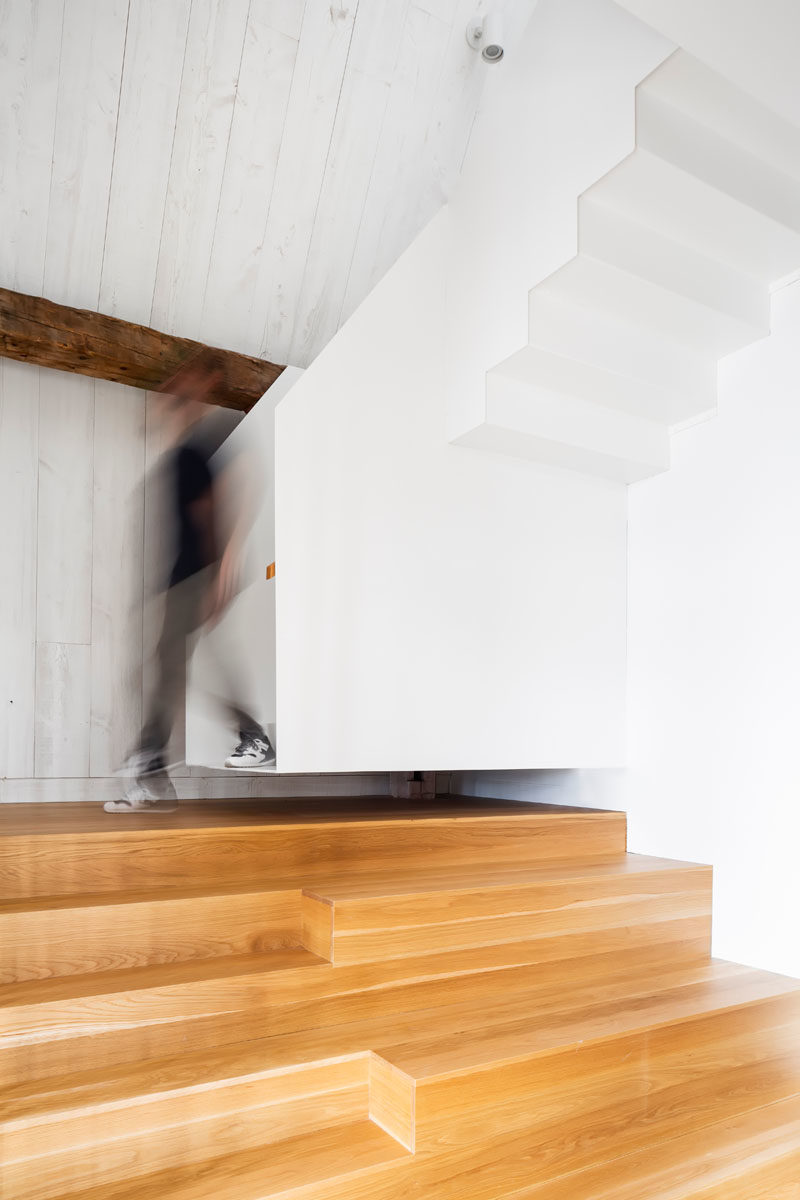 Stair Ideas - A light wood and white staircase connects the various levels of this modern barn. #StairIdeas #ModernStairs
