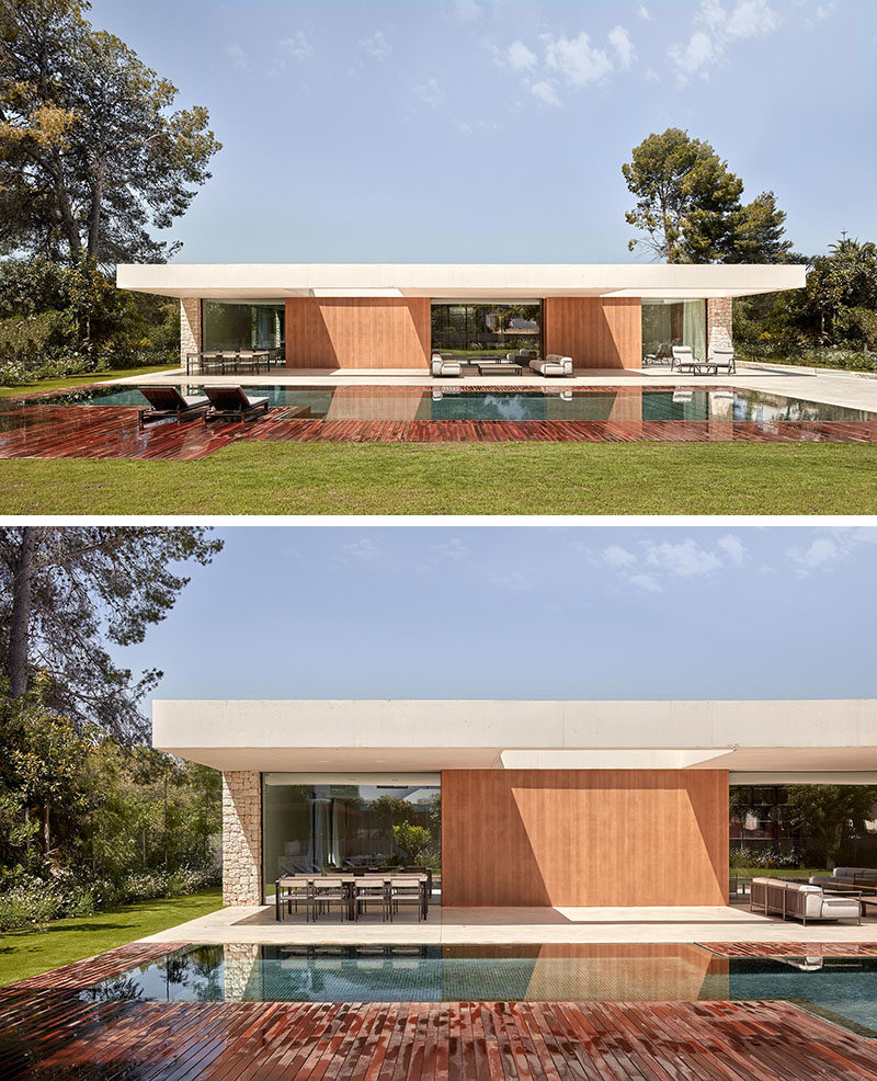 Outdoor Space - This modern house has an outdoor space that sits below a large cantilever of white concrete that has two perforations to allow the entrance of sunlight. #OutdoorSpace #Architecture #SwimmingPool #ModernHouse