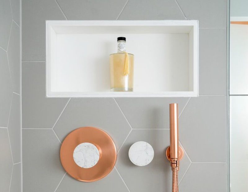 A great way to add storage and style to a bathroom is by creating a shower niche. A shower niche replaces the need for a corner shelf or a hanging caddy, and adds a luxurious touch to the bathroom. #ShowerNicheIdeas #ShowerNiche #ModernBathroom #BathroomStorage #ShowerShelf #ShowerNook