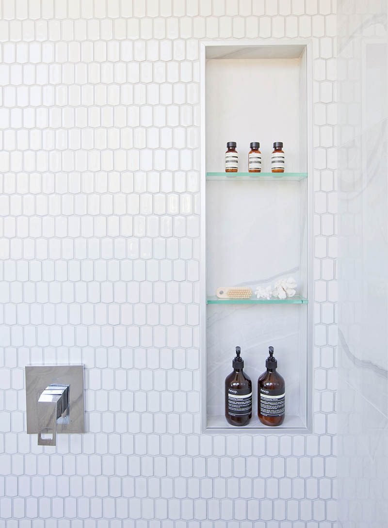 A great way to add storage and style to a bathroom is by creating a shower niche. A shower niche replaces the need for a corner shelf or a hanging caddy, and adds a luxurious touch to the bathroom. #ShowerNicheIdeas #ShowerNiche #ModernBathroom #BathroomStorage #ShowerShelf #ShowerNook