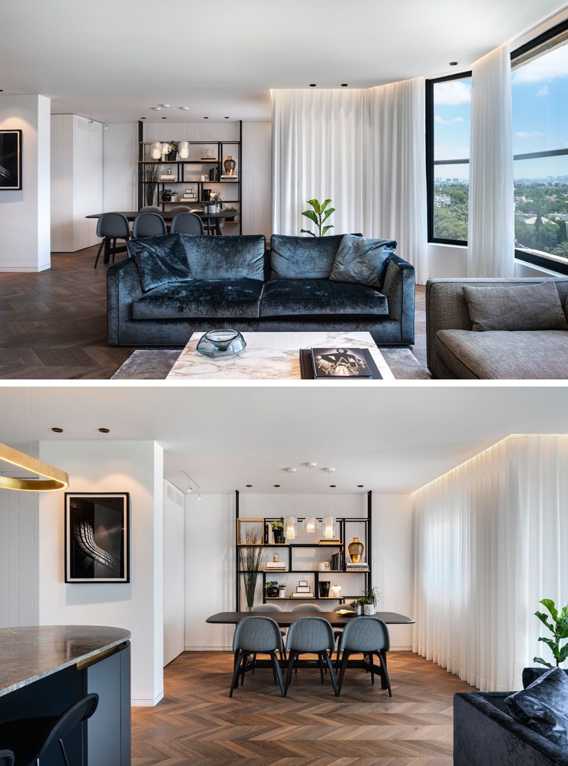 The surface of the dining table in this modern dining area, is blackened oak veneer, while above it, there's three pendant lights that are made from concave Carrera marble and geometric glass forms. A custom- designed, floating, black-painted metal and brass bookshelf creates a dedicated area to show off decorative items. #DiningRoomIdeas #ModernDiningRoom #Shelving #ShelvingIdeas