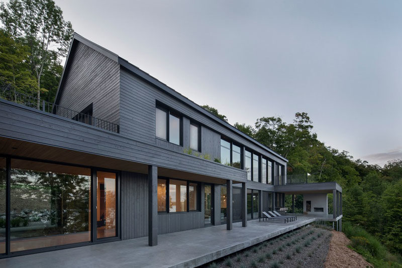 Modern Barnhouse Ideas - This modern barnhouse is designed as two separate areas, the first, a combined guest loft, garage and artist studio, that's connected by a glass tunnel to the second, the main house. #ModernBarnhouse #ModernArchitecture #BarnhouseDesign