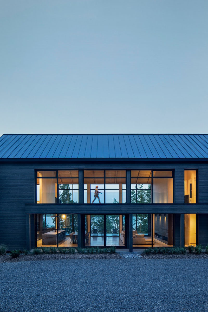 Window Ideas - This modern barnhouse has a large open-plan great room that's lined with a wall of windows. #ModernBarnhouse #Windows #ModernArchitecture