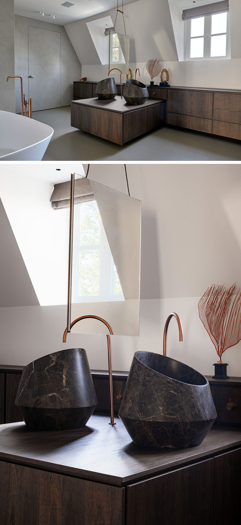 Modern Vanity Ideas - In this master bedroom, dual stone basins sit opposite each other atop a wood vanity, sharing a double-sided hanging mirror. #BathroomVanity #VanityIdeas #ModernBathroom