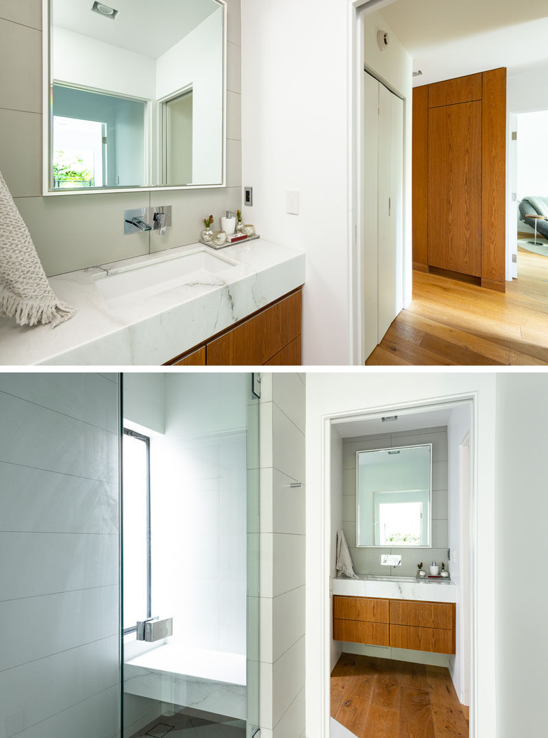 This modern bathroom that's hidden behind a pocket door, has a built-in wood vanity that matches the wood in the hall. #ModernBathroom #BathroomDesign #BathroomVanity