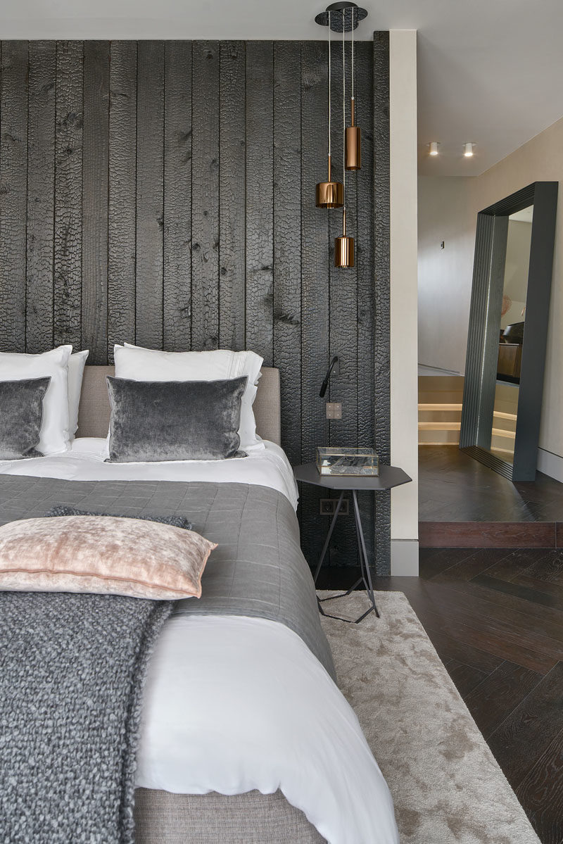 Bedroom Ideas - In this modern master bedroom, a burnt wood (shou sugi ban) accent wall creates a bold statement in the room. #BedroomIdeas #AccentWall #BurntWoodWall #ShouSugiBan