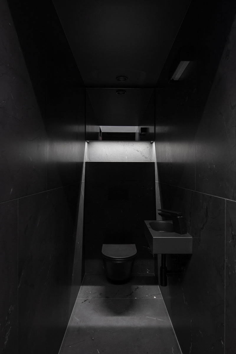 Bathroom Ideas - A modern black bathroom has matching black fixtures, that seamlessly blend into their surroundings. #BathroomIdeas #BlackBathroom #ModernBathroom