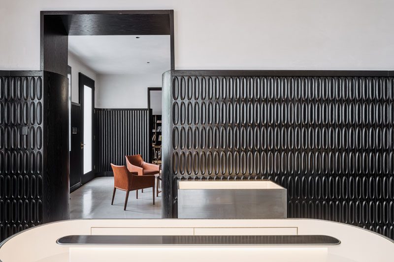 A dramatic design accent was created in this modern house, by adding black wainscoting that covers two thirds of the walls. #ModernInterior #BlackWainscoting #InteriorDesign #Interiors #BlackTiles