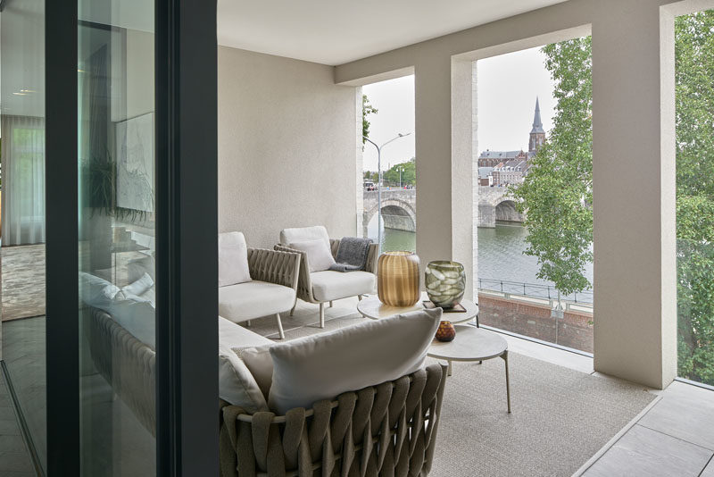 Outdoor Spaces - This modern penthouse apartment has a covered outdoor patio that overlooks the nearby river. #OutdoorSpace #CoveredPatio #OutdoorLounge