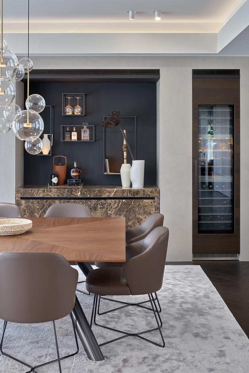 Dining Room Ideas - This modern dining room has a recessed home bar and a separate built-in wine fridge. #DiningRoomIdeas #ModernHomeBar #BuiltInBar #BuiltInWineFridge #WineStorage