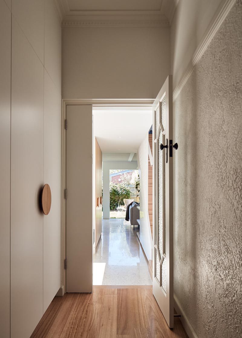 This hallway connects a new and modern extension with the original house. Opposite the front door are stairs that lead to a new second floor of the extension. #ModernHallway