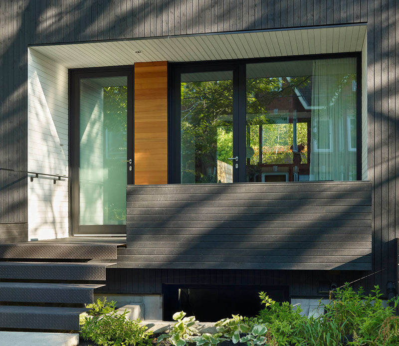 Door Ideas - At the front of this modern house, there's a second entrance that sits next to the front door. As the home owners are avid cyclists, the entrance provides direct access to a lower level with bike storage. #DoorIdeas #FrontDoors #Architecture