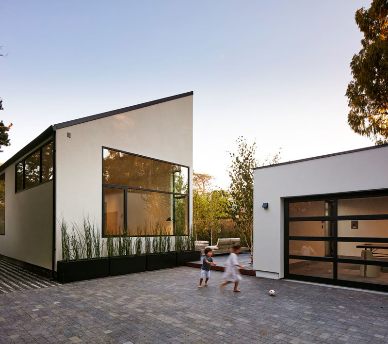 The courtyard of this modern house leads to the detached two car garage is insulated and can be used as a play room or office, if needed. #Architecture #Garage #ModernHouse