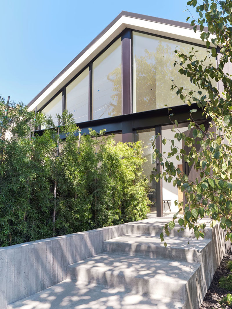 Minimalist concrete stairs lead from the sidewalk up to the front door. #Landscaping #ConcreteStairs