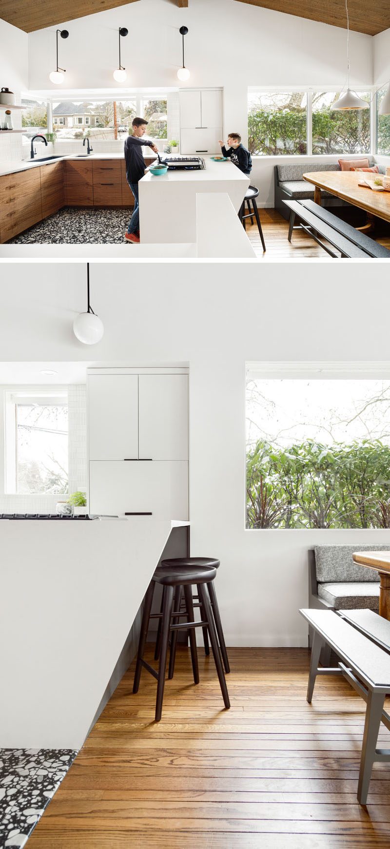 This remodeled kitchen has a bright and modern appearance with a large peninsula, wood cabinets, and a dining area with banquette seating. #ModernKitchen #WhiteKitchen #WoodKithen #KitchenDesign