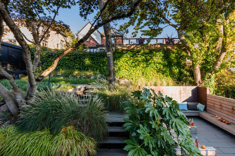 A sunken courtyard is adjacent to a raised garden with steps.