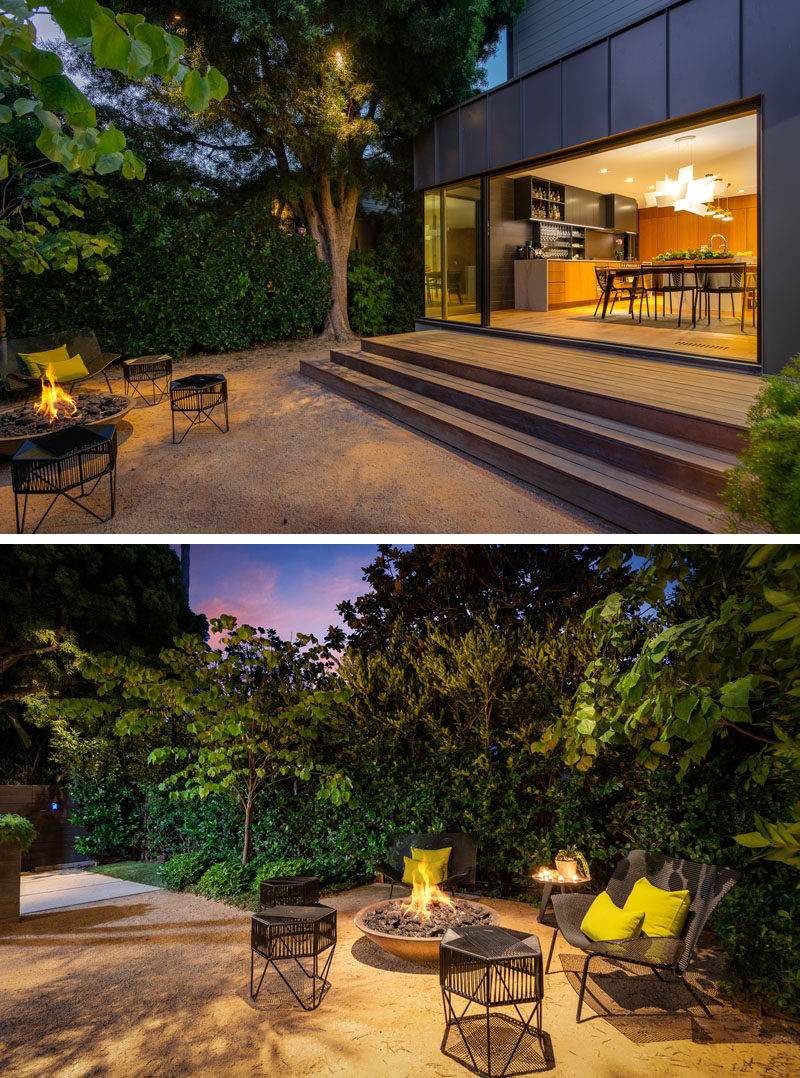 This modern house has exterior steps that lead from the dining room down to a small courtyard with seating and a fire bowl. #FireBowl #OutdoorEntertaining #OUtdoorSeating