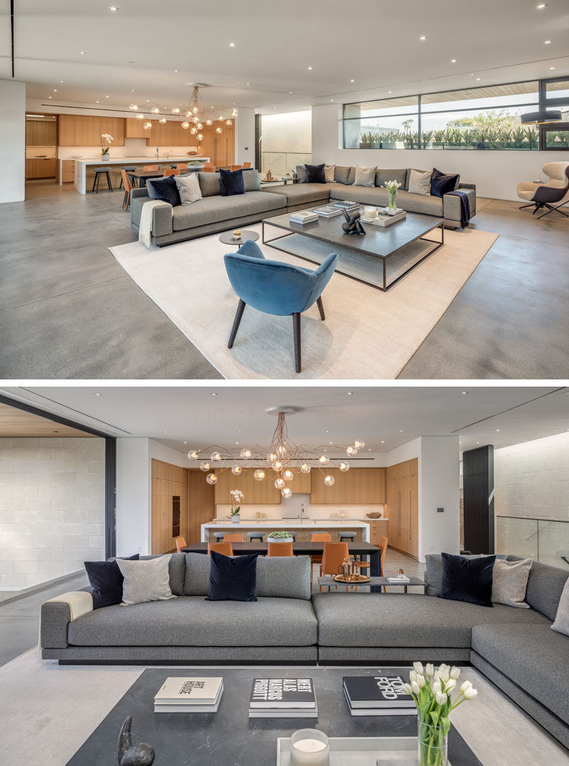 A large light colored rug helps to anchor the living room in this modern open plan interior. 