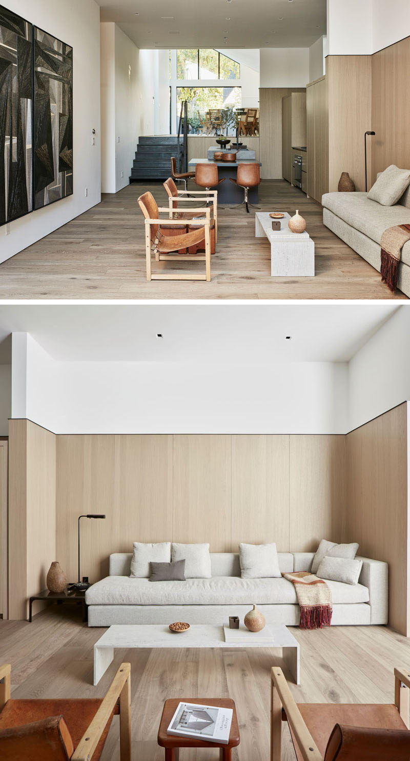 This modern house has a living area that opens to a courtyard at the back of the house. White oak floors have been used throughout the home. #ModernInterior #LivingRoom #Courtyard