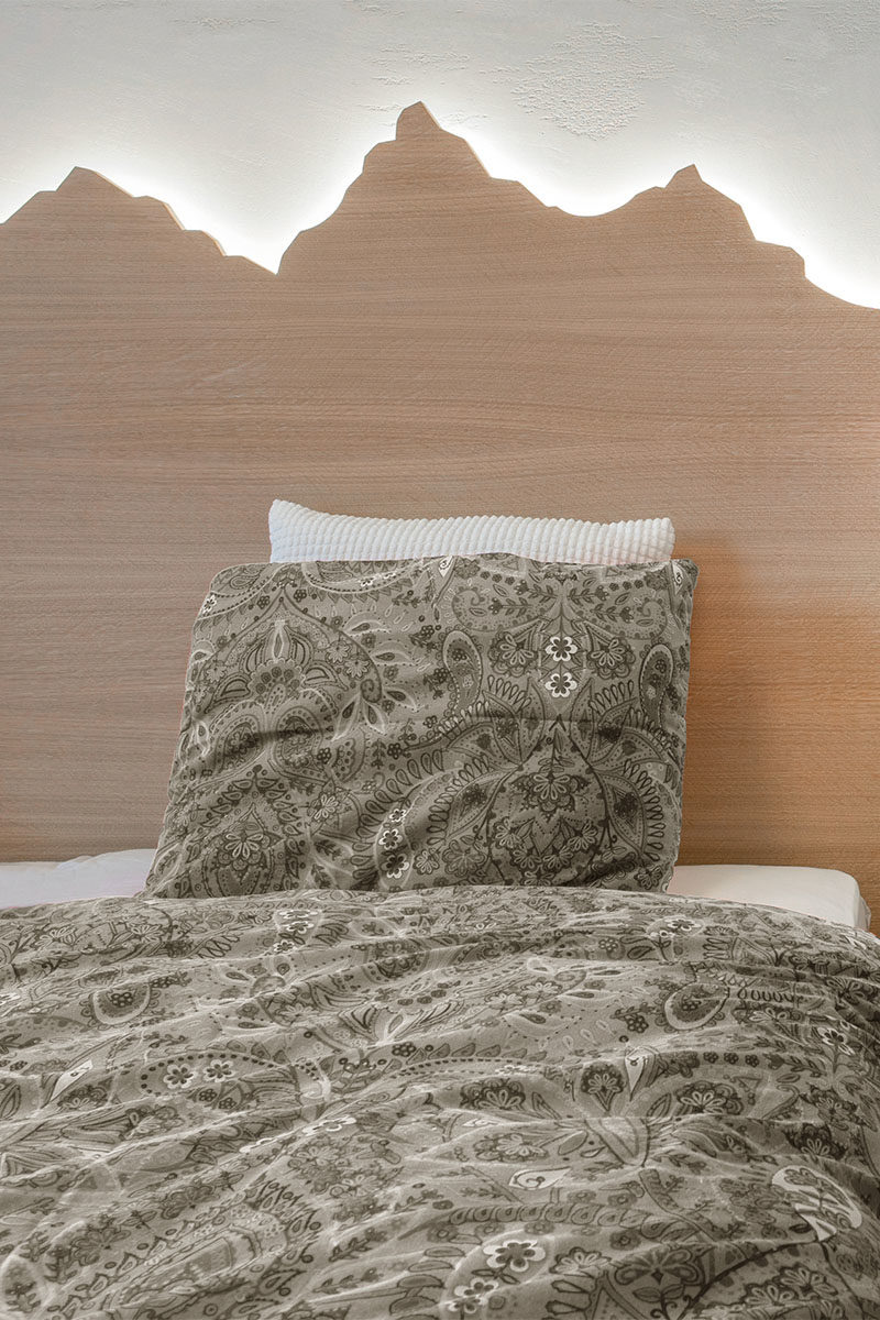 headboard Ideas - Using a mountain range as inspiration, this custom wood headboard with hidden lighting showcases the outline of the mountains and creates a soft glow for the bedroom. #HeadboardIdeas #ModernHeadboard #BedroomIdeas #BacklitHeadboard #ModernBedroom