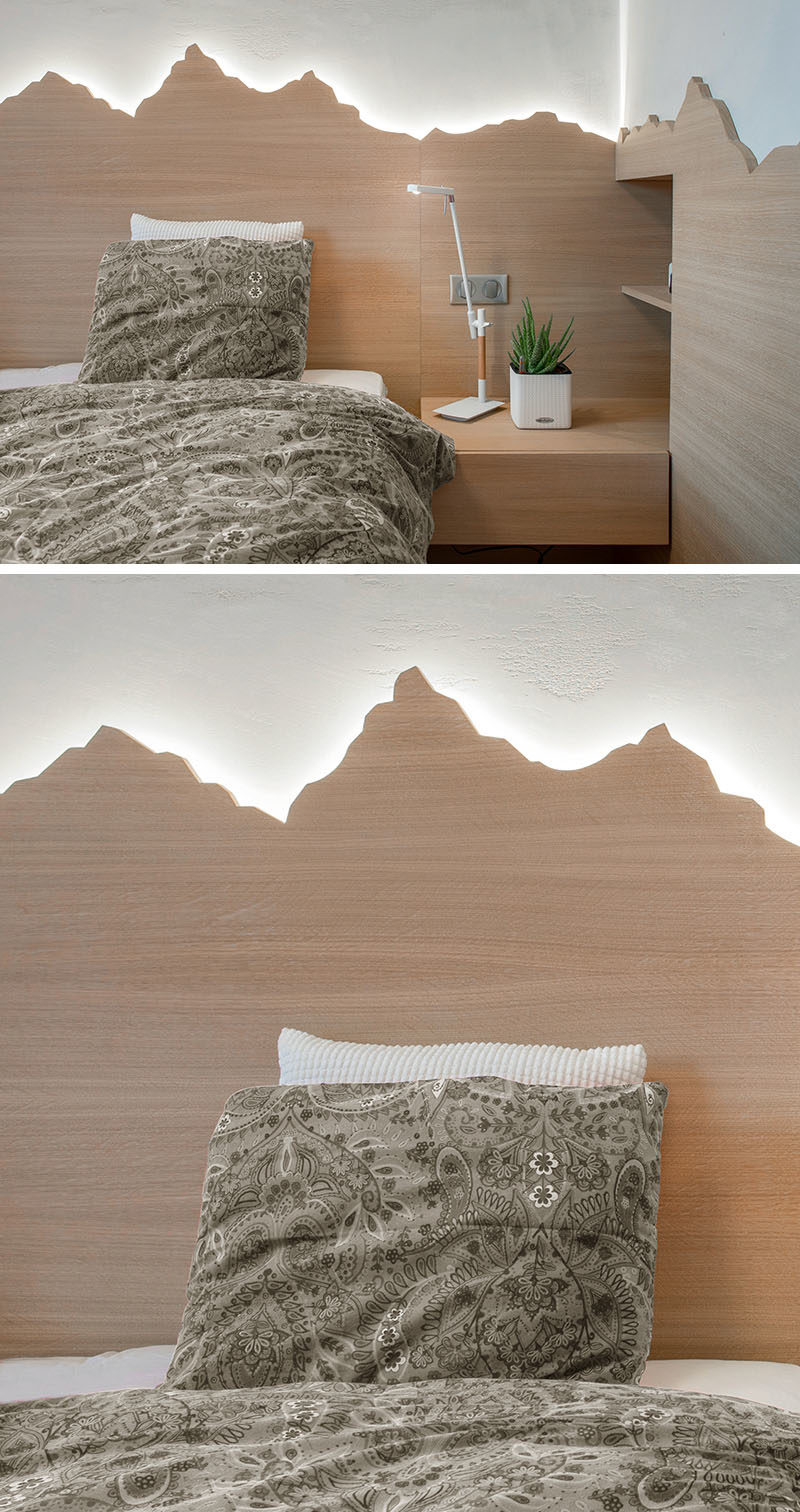 headboard Ideas - Using a mountain range as inspiration, this custom wood headboard with hidden lighting showcases the outline of the mountains and creates a soft glow for the bedroom. #HeadboardIdeas #ModernHeadboard #BedroomIdeas #BacklitHeadboard #ModernBedroom