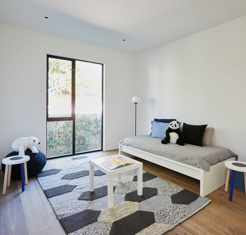 In this children's bedroom, blue accents add a pop of color to a neutral palette. #ModernBedroom #BedroomDesign #KidsBedroom