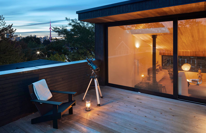 Stairs lead from the living room of this modern to an outdoor terrace, that offers enjoyment of the city skyline, urban tree canopy, sunsets, and the night sky. #OutdoorTerrace #ModernHouse #RooftopDeck