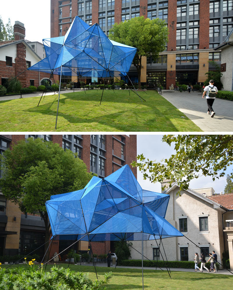 This modern public art installation named 'Cobalt Muffin', has a geometric shape that floats over a lawn, with the design made from 60 similar triangles, that have been covered with a semi-transparent skin made from more than 4 miles (7.5 km) of elastic ropes, creating a vibrant addition to the area. #ModernArt #ArtInstallation #PublicSculpture