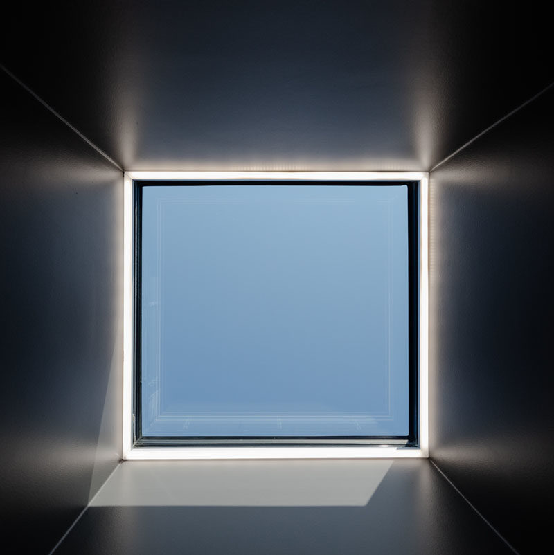 Window Ideas - A square skylight filters natural light through to a mostly dark space. #Skylight #ModernWindow #WindowIdeas #SkylightIdeas