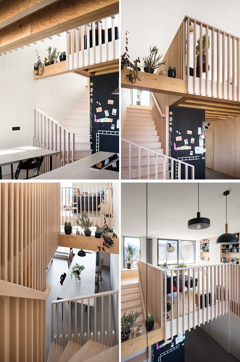 Stairs beside a black chalkboard wall lead up to the upper floor of this modern house. Wooden slats were used for the handrails and parapet and serve as a guideline throughout the house. #WoodStairs #ModernStairs #StairDesign