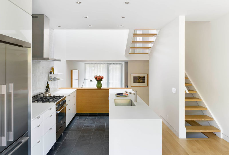 Kitchen Ideas - High ceilings make this mostly white kitchen and dining room feel open and bright. #WhiteKitchen #KitchenDesign #KitchenIdeas