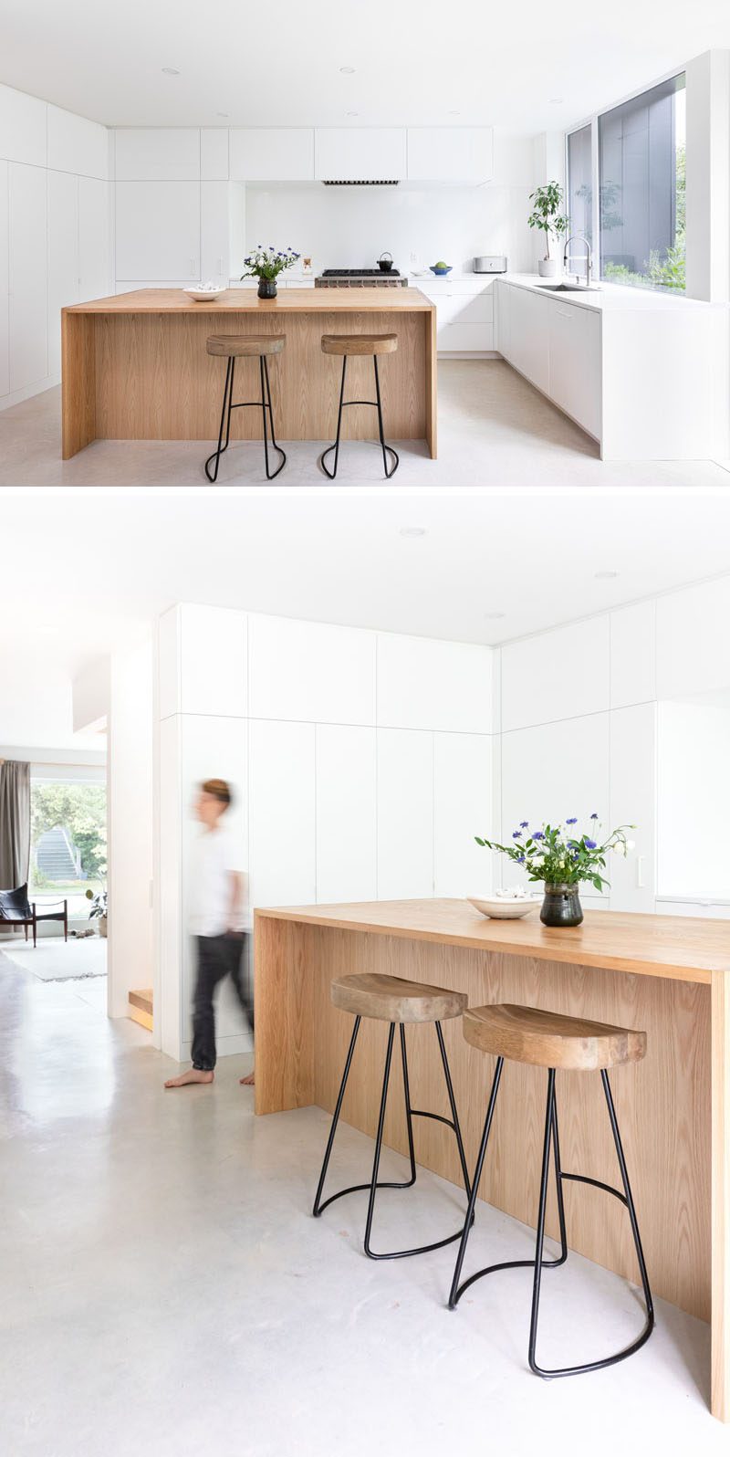 This modern kitchen brings nature inside with the use of a wood island, while white countertops and minimalist hardware free cabinets blend seamlessly into the white walls. #WhiteKitchen #WoodKitchenIsland #ModernKitchen #MinimalistWhiteCabinets